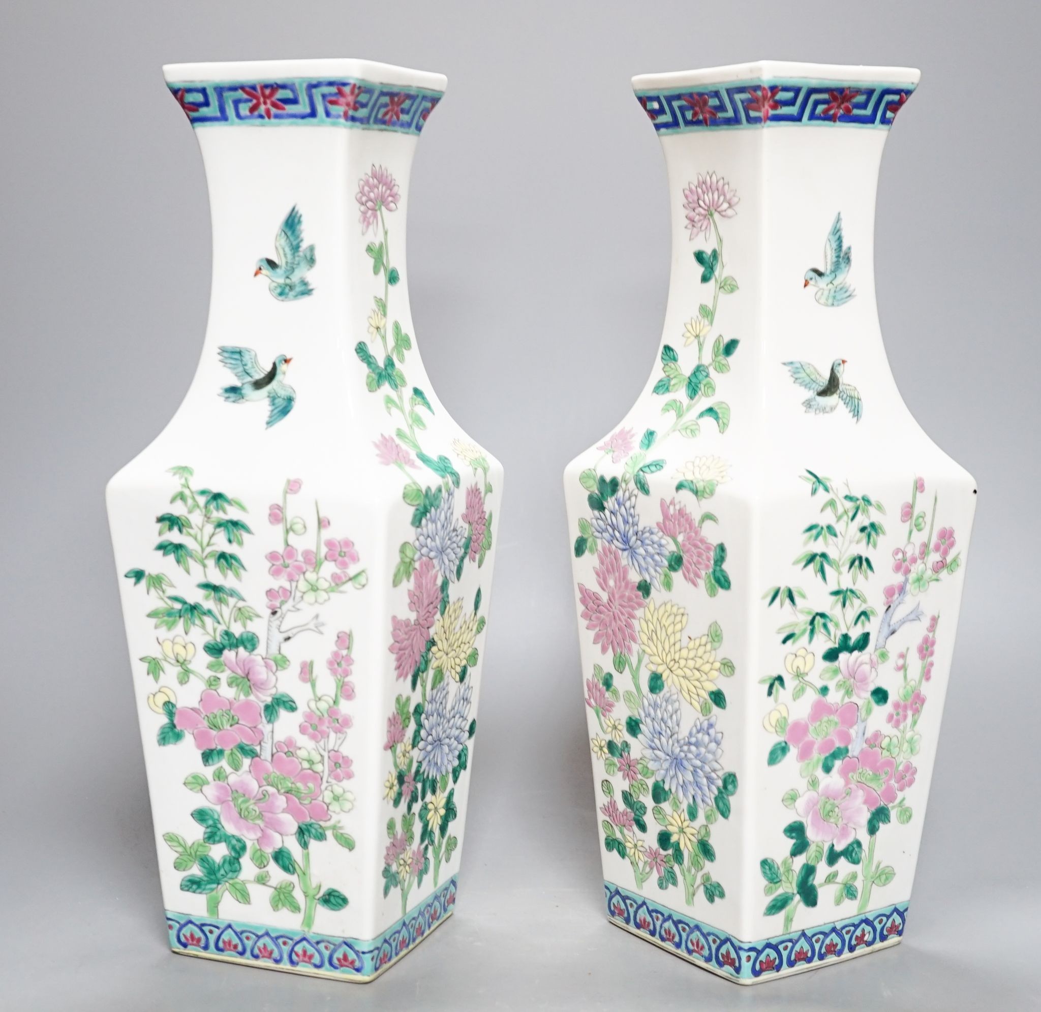 A pair of Chinese famille rose square baluster vases, and another famille rose vase, 37cm